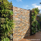 Rusty charcoal stack stone cladding installed on modern feature wall
